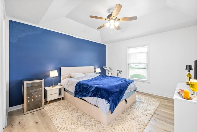 202 Jim Thorpe Dr, Clarksville, TN 37042 - bedroom featuring beverage cooler, a raised ceiling, wood finished floors, ceiling fan, and baseboards