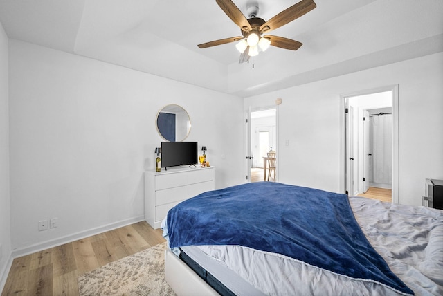 202 Jim Thorpe Dr, Clarksville, TN 37042 - bedroom featuring light wood-style floors, a raised ceiling, baseboards, ensuite bath, and ceiling fan