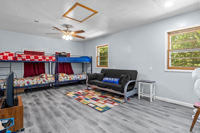 1090 Eva Harbor Rd, Eva, TN 38333 - bedroom featuring wood finished floors, baseboards, a ceiling fan, and attic access