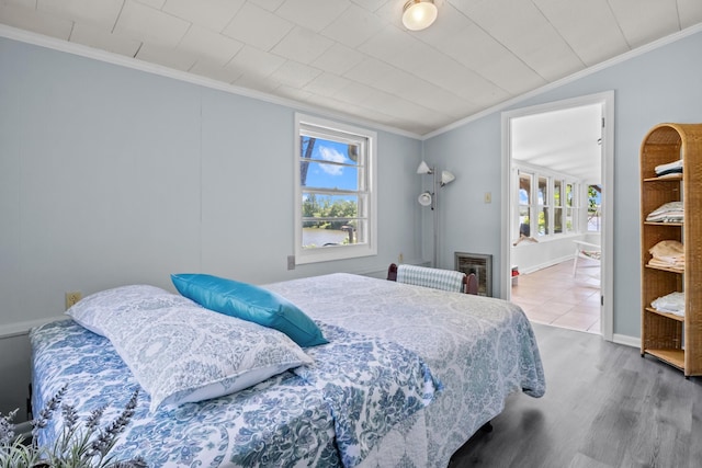 1090 Eva Harbor Rd, Eva, TN 38333 - bedroom featuring ornamental molding, vaulted ceiling, wood finished floors, and baseboards