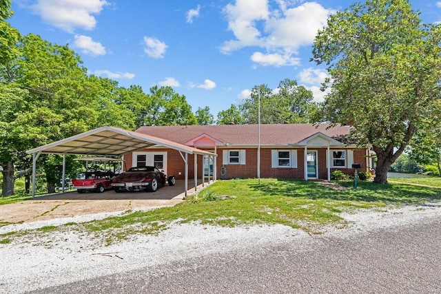 1090 Eva Harbor Rd, Eva, TN 38333 - ranch-style home with a front lawn, brick siding, and driveway