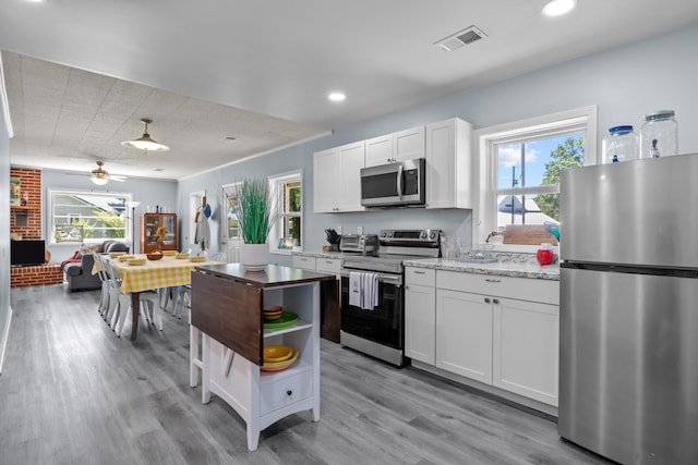 1090 Eva Harbor Rd, Eva, TN 38333 - kitchen featuring appliances with stainless steel finishes, light wood-style floors, white cabinetry, recessed lighting, and open shelves