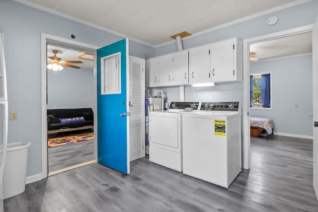 1090 Eva Harbor Rd, Eva, TN 38333 - laundry area featuring crown molding, washer and dryer, cabinet space, wood finished floors, and a ceiling fan