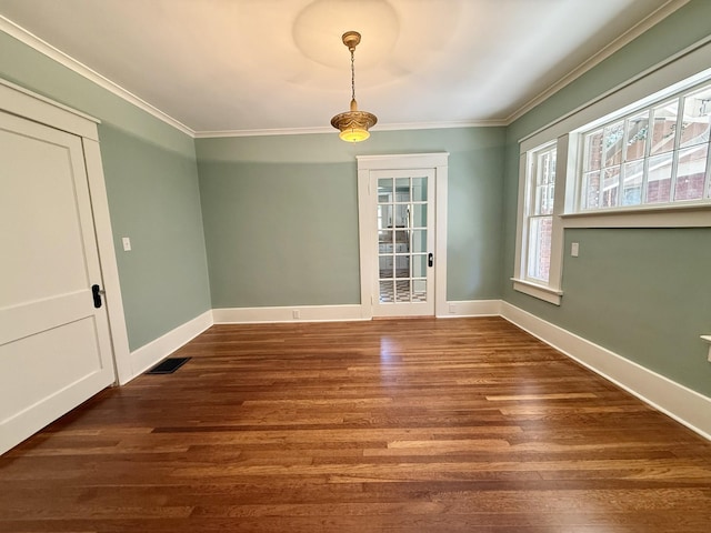 425 Arlington Ave, Jackson, TN 38301 - unfurnished dining area with crown molding, dark wood finished floors, and baseboards