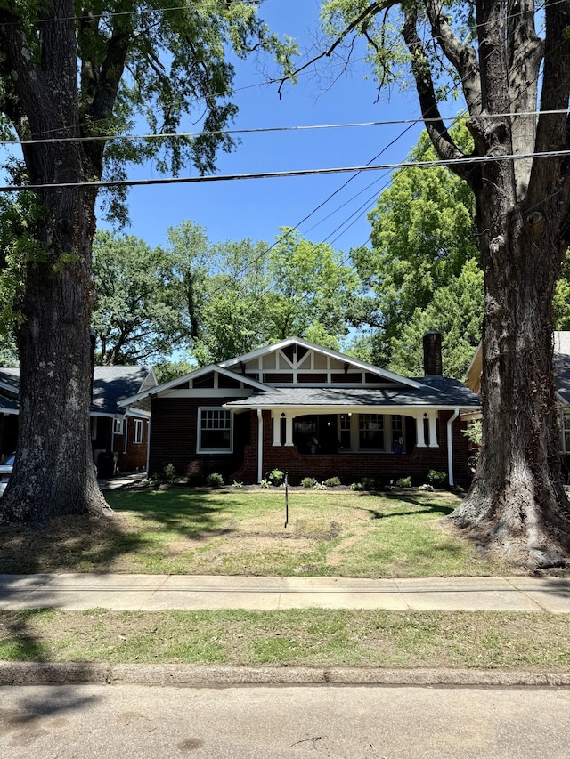 425 Arlington Ave, Jackson, TN 38301 - view of front of property with a chimney, a front yard, and brick siding