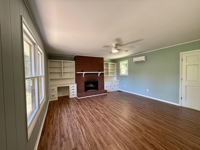 425 Arlington Ave, Jackson, TN 38301 - unfurnished living room with a wall unit AC, dark wood-type flooring, ceiling fan, baseboards, and a fireplace