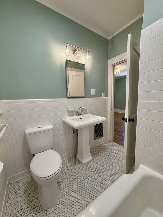 425 Arlington Ave, Jackson, TN 38301 - full bathroom with tile walls, a bath, ornamental molding, tile patterned floors, and toilet