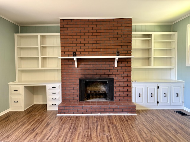 425 Arlington Ave, Jackson, TN 38301 - unfurnished living room with dark wood-style floors, crown molding, a fireplace, and baseboards