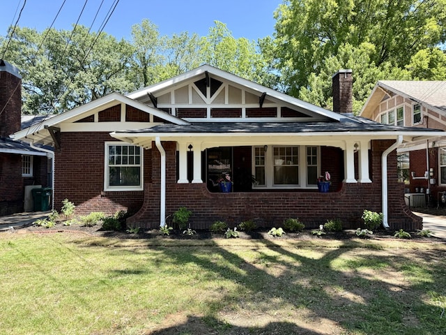 425 Arlington Ave, Jackson, TN 38301 - view of front of house featuring a chimney, a front yard, and brick siding