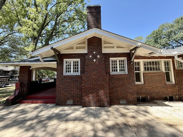425 Arlington Ave, Jackson, TN 38301 - view of home's exterior featuring a chimney, brick siding, and crawl space