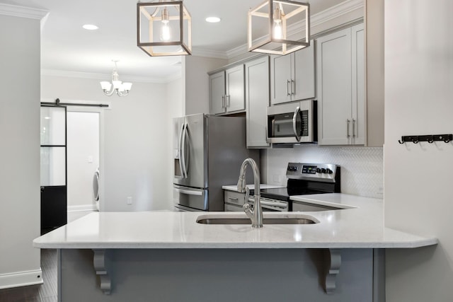 229 Claremont Ct, Gallatin, TN 37066 - kitchen featuring stainless steel appliances, gray cabinets, a sink, a barn door, and decorative backsplash