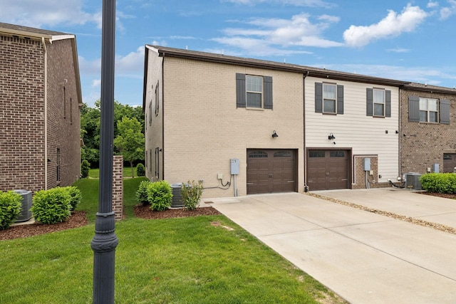 229 Claremont Ct, Gallatin, TN 37066 - back of property with central AC unit, concrete driveway, a lawn, and brick siding