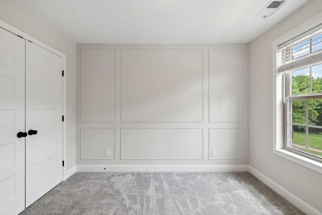229 Claremont Ct, Gallatin, TN 37066 - unfurnished bedroom with multiple windows, carpet floors, baseboards, and a closet