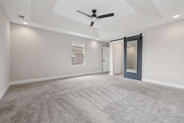 229 Claremont Ct, Gallatin, TN 37066 - unfurnished bedroom with a raised ceiling, a barn door, carpet, recessed lighting, and baseboards