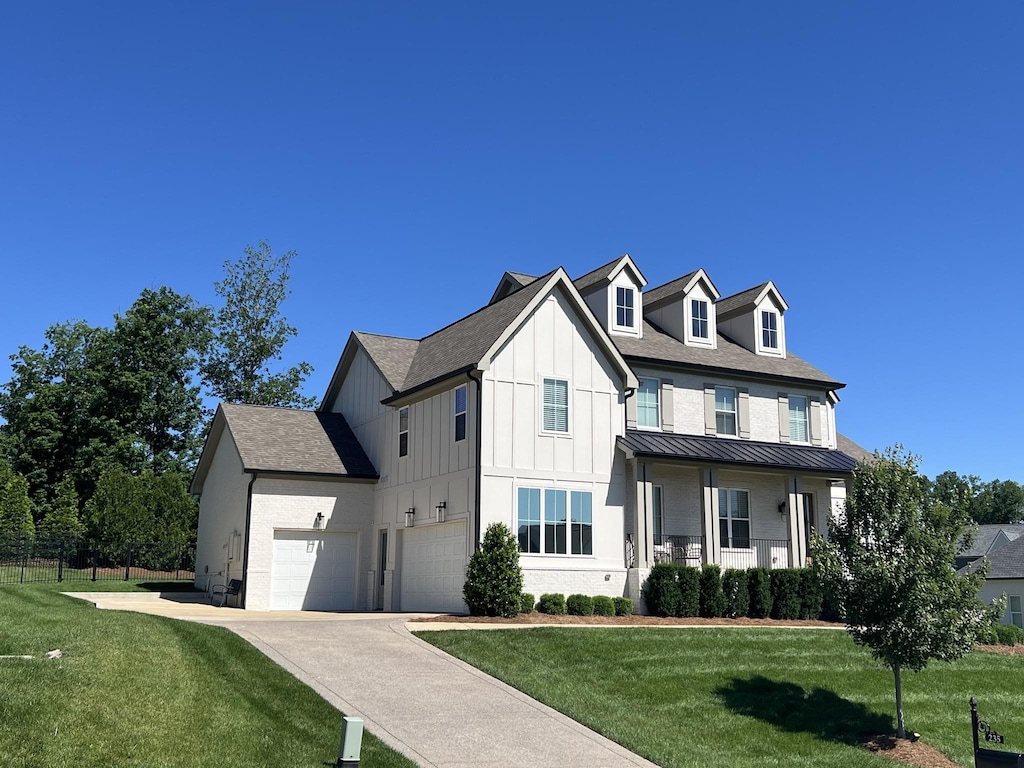 235 Belgian Rd, Nolensville, TN 37135 - modern farmhouse featuring a front yard, a standing seam roof, concrete driveway, board and batten siding, and metal roof