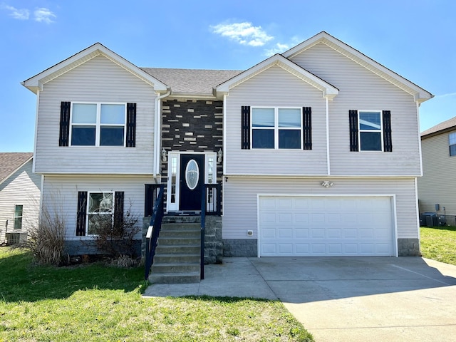 1284 Freedom Dr, Clarksville, TN 37042 - split foyer home featuring an attached garage, a front yard, driveway, and central AC