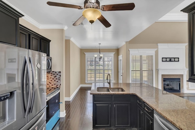 499 Williamsport Dr, Smyrna, TN 37167 - kitchen featuring appliances with stainless steel finishes, a sink, ceiling fan, a fireplace, and light stone countertops