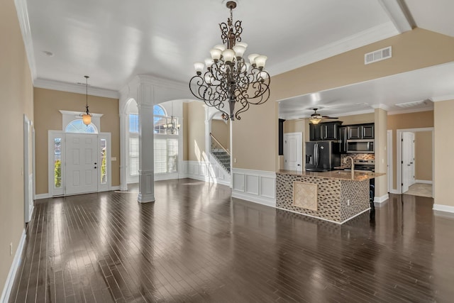 499 Williamsport Dr, Smyrna, TN 37167 - entryway featuring a chandelier, arched walkways, ceiling fan, decorative columns, and dark wood-style floors