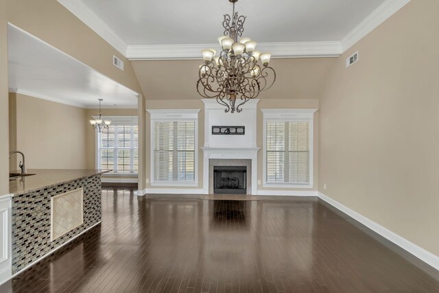499 Williamsport Dr, Smyrna, TN 37167 - unfurnished living room with a chandelier, dark wood-style floors, baseboards, a fireplace, and ornamental molding