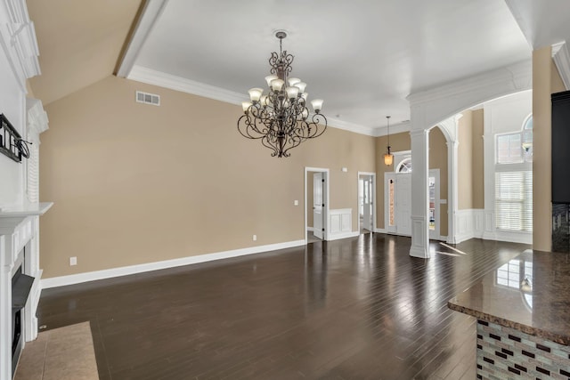 499 Williamsport Dr, Smyrna, TN 37167 - unfurnished living room featuring arched walkways, ornate columns, a fireplace with flush hearth, dark wood-style flooring, and a chandelier