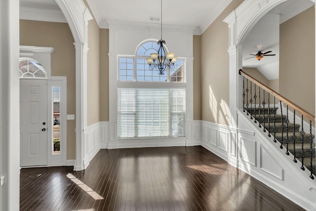 499 Williamsport Dr, Smyrna, TN 37167 - foyer entrance featuring arched walkways, a chandelier, ceiling fan, ornate columns, and a wainscoted wall
