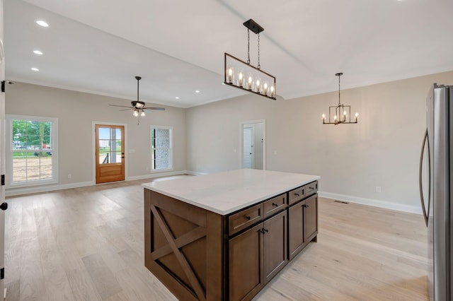 2121 Halls Mill Rd, Unionville, TN 37180 - kitchen with freestanding refrigerator, light wood-style flooring, baseboards, a chandelier, and ornamental molding