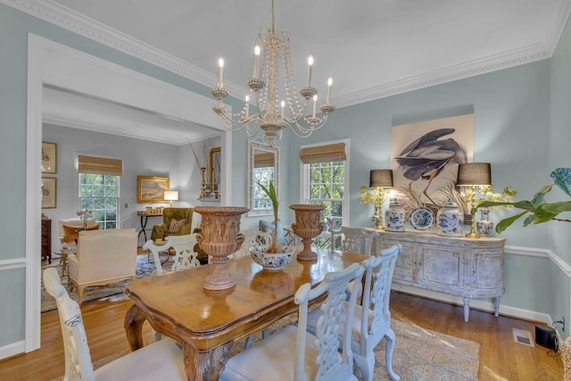 216 Chestnut Hill Dr, Nashville, TN 37215 - dining room with healthy amount of natural light, wood finished floors, ornamental molding, a chandelier, and baseboards