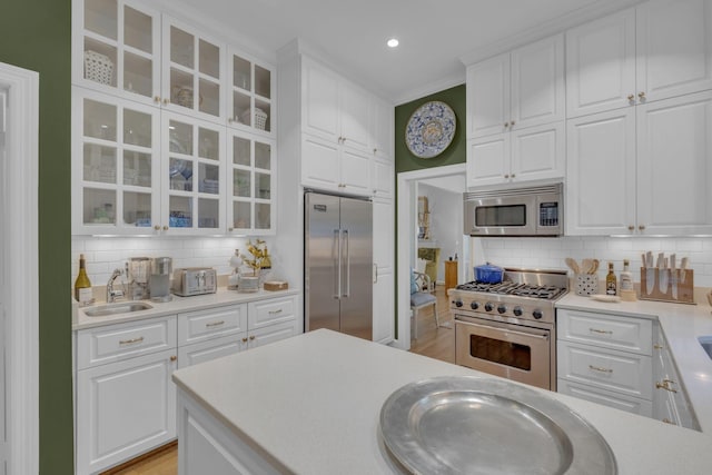 216 Chestnut Hill Dr, Nashville, TN 37215 - kitchen featuring premium appliances, a sink, tasteful backsplash, white cabinets, and recessed lighting