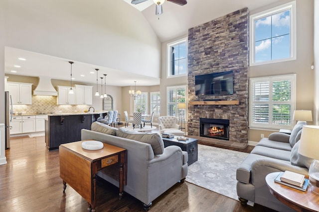 5108 Duckhorn Ct, Franklin, TN 37067 - living room featuring a ceiling fan, dark wood finished floors, high vaulted ceiling, a fireplace, and a chandelier