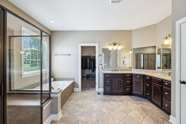 5108 Duckhorn Ct, Franklin, TN 37067 - full bathroom featuring double vanity, a shower stall, a garden tub, a spacious closet, and a chandelier