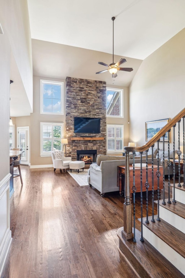 5108 Duckhorn Ct, Franklin, TN 37067 - living area featuring wood finished floors, a stone fireplace, a ceiling fan, high vaulted ceiling, and stairway