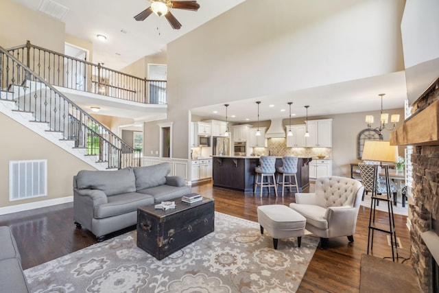 5108 Duckhorn Ct, Franklin, TN 37067 - living room featuring ceiling fan, dark wood finished floors, stairway, a high ceiling, and baseboards