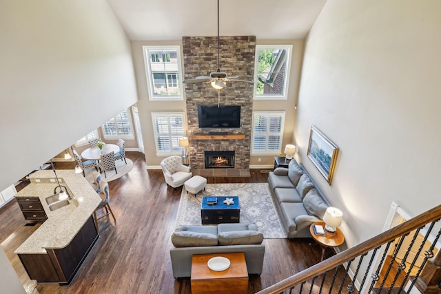 5108 Duckhorn Ct, Franklin, TN 37067 - living area featuring a stone fireplace, high vaulted ceiling, dark wood finished floors, ceiling fan, and baseboards