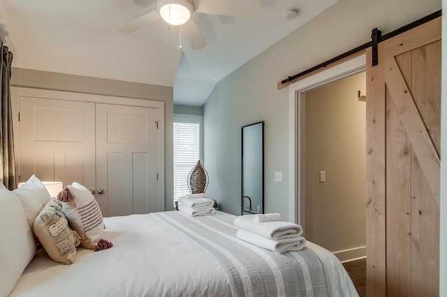 2021 Beech Ave Unit 5, Nashville, TN 37204 - bedroom with a barn door, a closet, vaulted ceiling, a ceiling fan, and baseboards