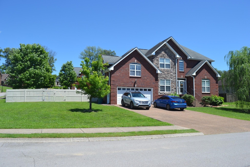 201 Abbey Rd, Lebanon, TN 37090 - view of front of home with driveway, a garage, and brick siding