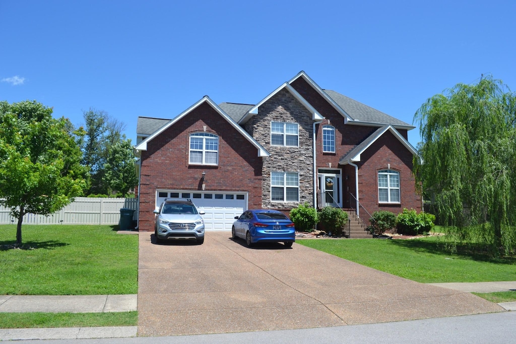 201 Abbey Rd, Lebanon, TN 37090 - view of front of home with concrete driveway, an attached garage, and brick siding