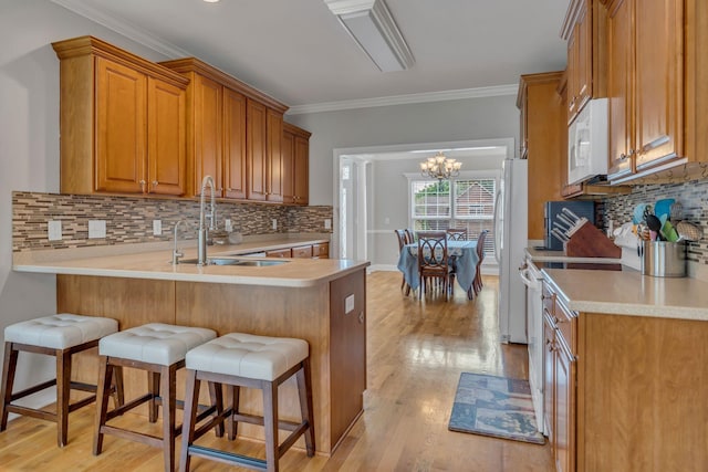 201 Abbey Rd, Lebanon, TN 37090 - kitchen featuring white appliances, brown cabinetry, light countertops, decorative backsplash, and ornamental molding