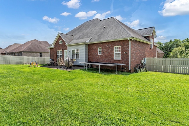 201 Abbey Rd, Lebanon, TN 37090 - back of property featuring a trampoline, a fenced backyard, a patio area, and roof with shingles