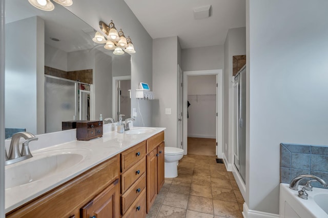 201 Abbey Rd, Lebanon, TN 37090 - bathroom featuring a shower stall, double vanity, a bath, a walk in closet, and stone finish flooring