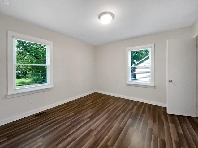 948 Oak St, Lewisburg, TN 37091 - unfurnished room with healthy amount of natural light, dark wood-style floors, and baseboards