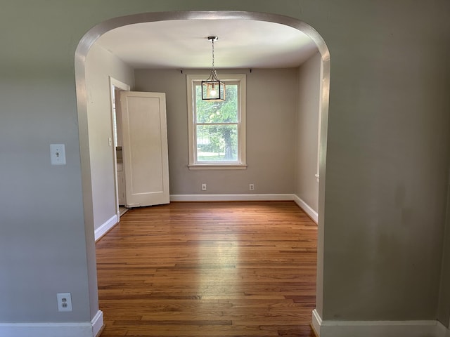 2910 Woodlawn Dr, Nashville, TN 37215 - unfurnished dining area featuring arched walkways, wood finished floors, and baseboards