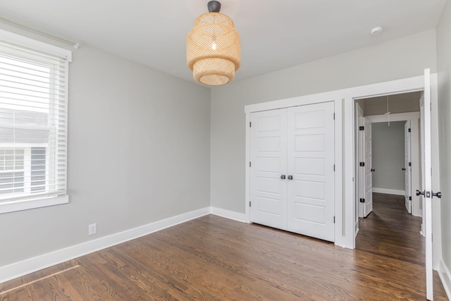 601 Lawrence St, Old Hickory, TN 37138 - unfurnished bedroom featuring a closet, baseboards, and dark wood-style flooring