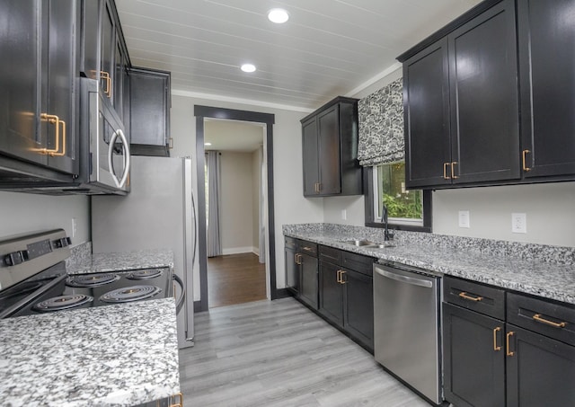 601 Lawrence St, Old Hickory, TN 37138 - kitchen with stainless steel appliances, a sink, light wood-type flooring, recessed lighting, and light stone counters
