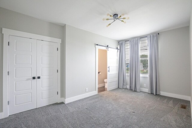601 Lawrence St, Old Hickory, TN 37138 - unfurnished bedroom with carpet, a barn door, a closet, and baseboards