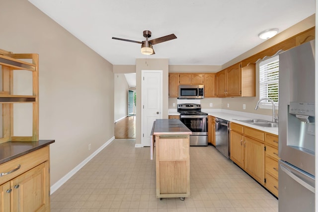 204 Nathan Dr, Goodlettsville, TN 37072 - kitchen with stainless steel appliances, a sink, a kitchen island, baseboards, and light flooring