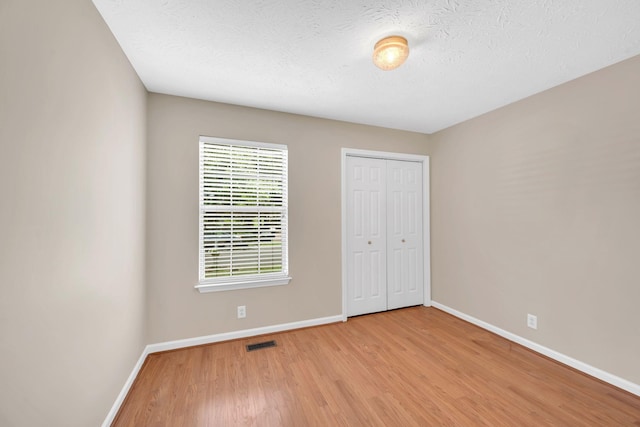 204 Nathan Dr, Goodlettsville, TN 37072 - unfurnished bedroom featuring baseboards, wood finished floors, a closet, and a textured ceiling