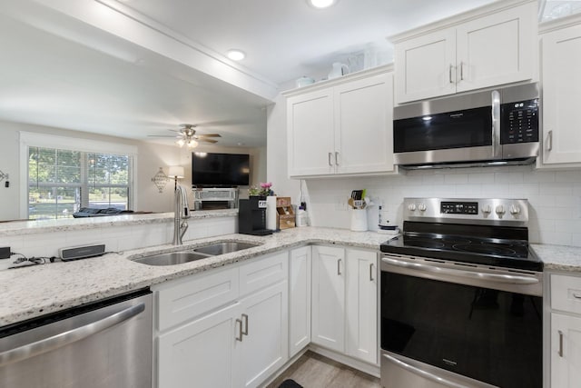 3021 Cambridge Ct, Lewisburg, TN 37091 - kitchen with appliances with stainless steel finishes, a sink, white cabinets, and tasteful backsplash
