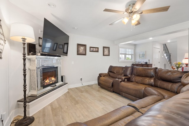 3021 Cambridge Ct, Lewisburg, TN 37091 - living room featuring a glass covered fireplace, wood finished floors, stairway, ceiling fan, and baseboards
