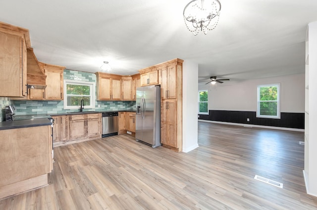 2897 Old Medina Rd, Jackson, TN 38305 - kitchen with appliances with stainless steel finishes, a sink, dark countertops, light wood finished floors, and open floor plan