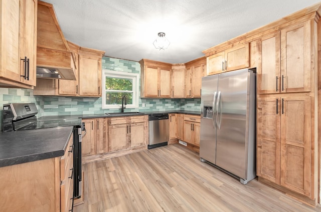 2897 Old Medina Rd, Jackson, TN 38305 - kitchen with appliances with stainless steel finishes, a sink, light wood-type flooring, dark countertops, and light brown cabinets